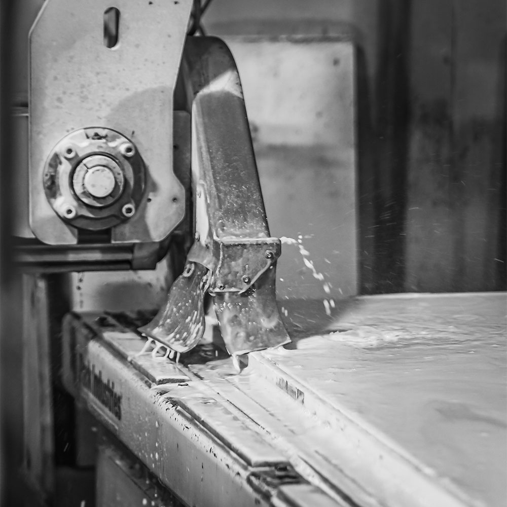 a machine polishing a stone slab